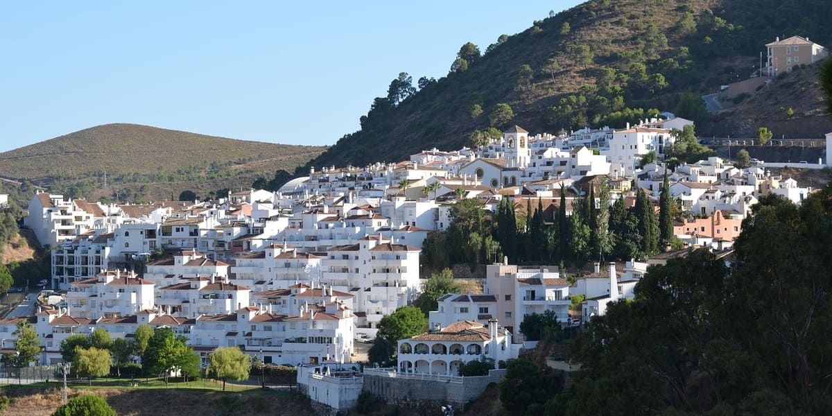 Vista panorámica del pueblo blanco de Benahavís en la Costa del Sol, destacando su arquitectura tradicional andaluza y entorno natural de montaña.