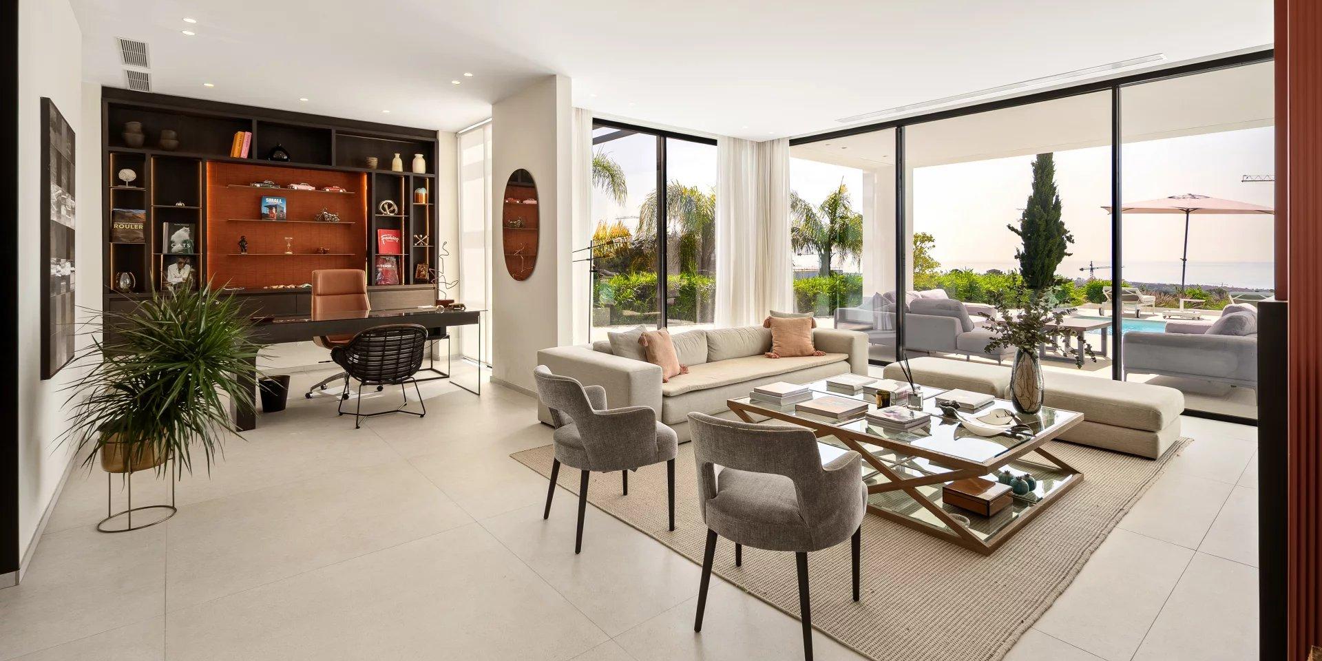 Bright modern living room of a Marbella apartment with floor-to-ceiling windows